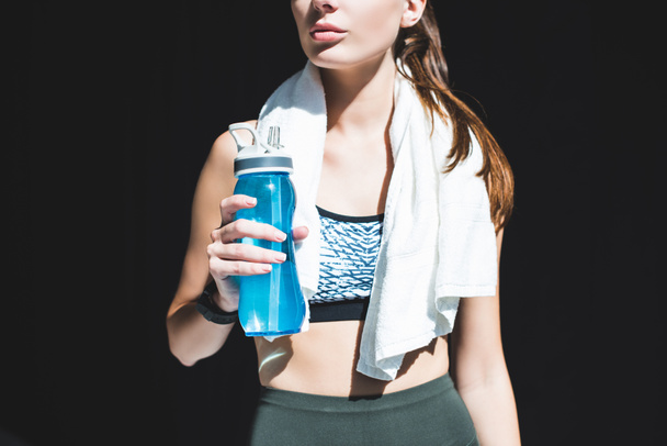 sportswoman with towel and bottle of water - Foto, Bild