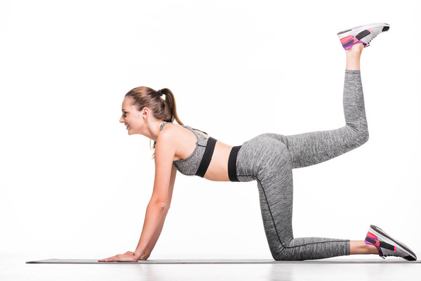 sportswoman exercising on yoga mat - Foto, Bild