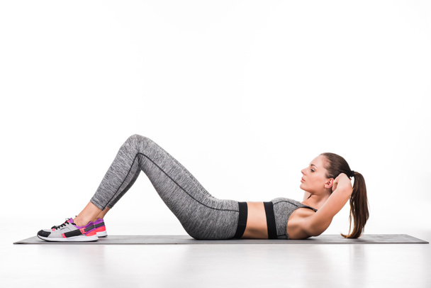sportswoman exercising on yoga mat - Zdjęcie, obraz