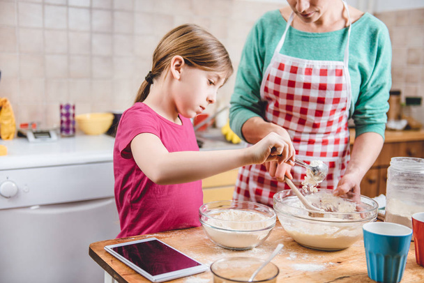 Daughter and mother making dough - Photo, Image