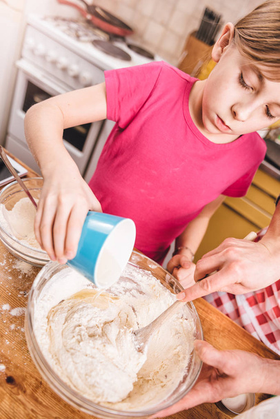 Daughter and mother making dough - 写真・画像