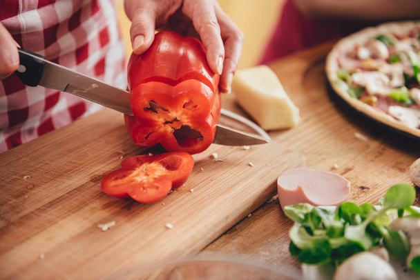 Woman slicing paprika  - Фото, изображение