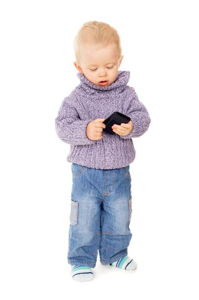 a little kid playing with a mobile phone - Foto, immagini