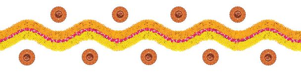 Stock illustration of flower rangoli or border pattern for Diwali or pongal made using marigold or zendu flowers and red rose petals over white background with diwali diya in the middle - Photo, Image