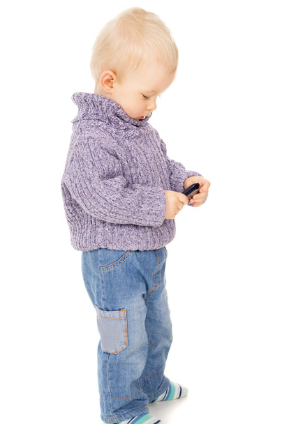 The little boy looks in the mobile phone - Foto, Bild