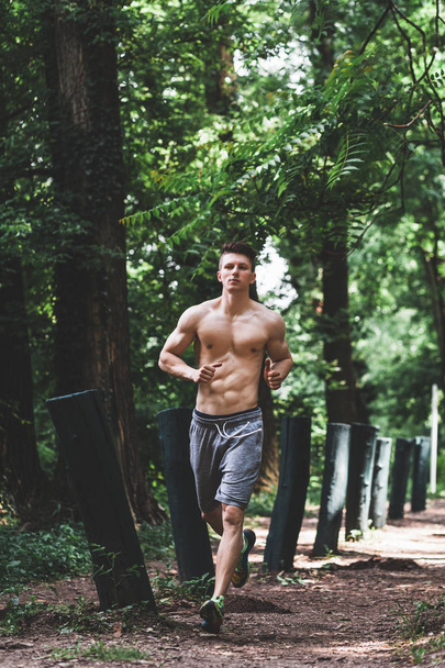 Young man running in the park - 写真・画像