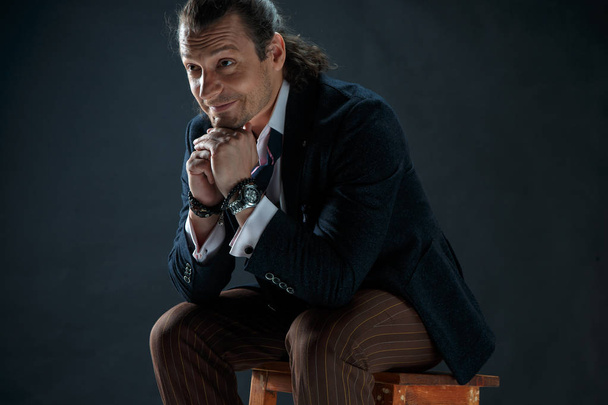 Businessman sitting on an armchair - Fotografie, Obrázek