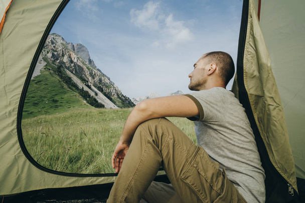 Male back in tent with mountain view in Montenegro, camper enjoy - Valokuva, kuva