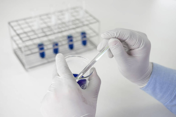 Scientist or medical in lab coat working in biotechnological lab - Фото, изображение