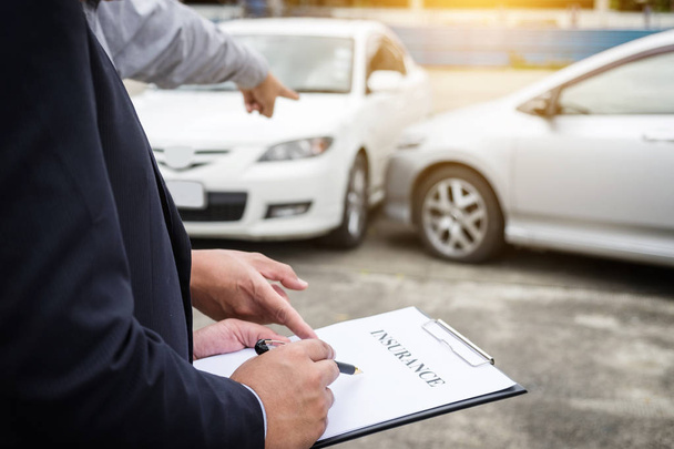 Insurance Agent examine Damaged Car and filing Report Claim Form - Fotoğraf, Görsel