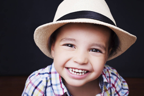 Emotional cute boy checkered shirt and straw hat  - Photo, image