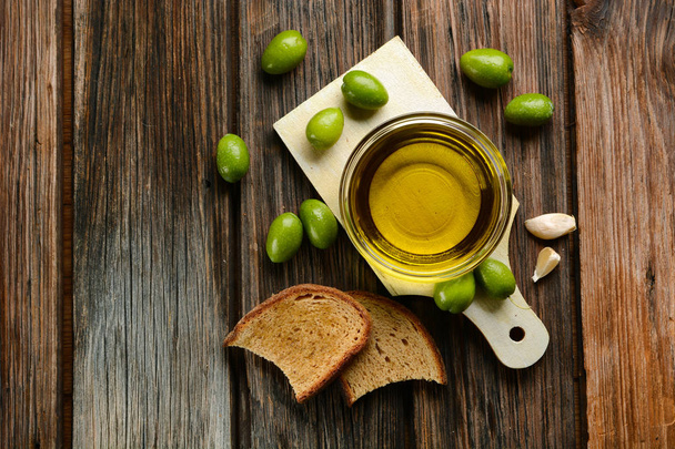 bread and olive oil on wooden table - 写真・画像