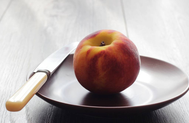 Fresh peach on rustic wooden table - Foto, afbeelding
