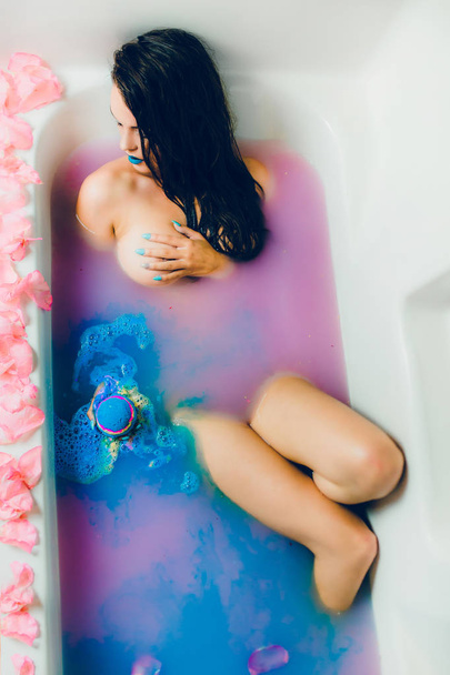 woman in blue water and petals - Zdjęcie, obraz