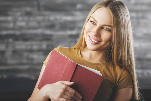 Smiling woman with book  - Φωτογραφία, εικόνα