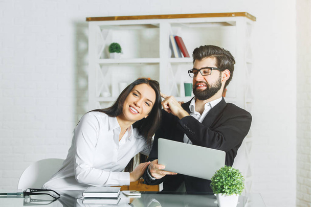 Businessman and woman playing at workplace. Playful concept  - Photo, Image