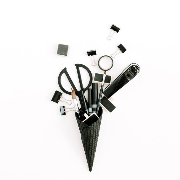 Black ice cream waffle cone with office stationery tools - Photo, Image