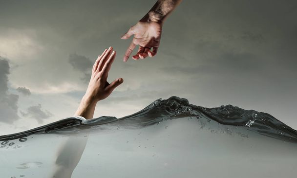 Hand of person drowning in water - 写真・画像
