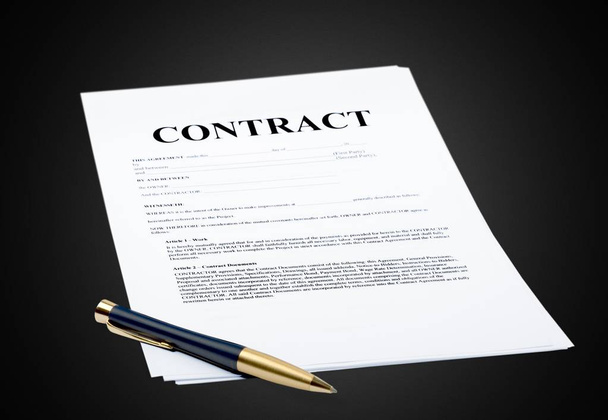 Pen and contract paper on black background - Фото, изображение