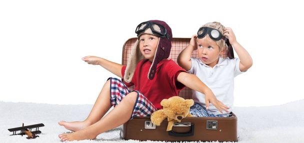 close-up photo of two cute boys in suitcase isolated on white background - Fotoğraf, Görsel