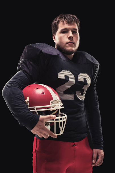 Football player on dark background - Foto, imagen