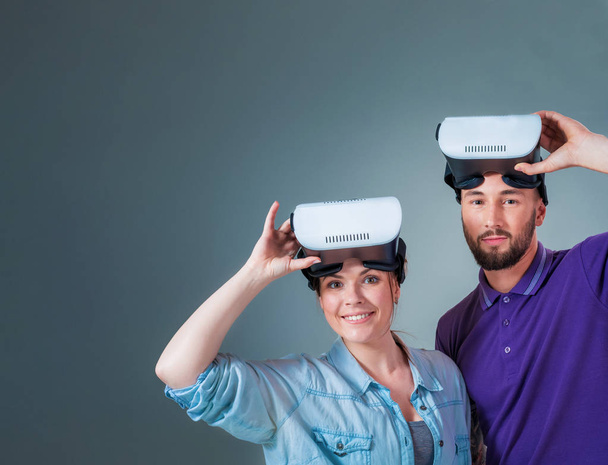 Excited young man and woman having fun with a VR glasses - Photo, image