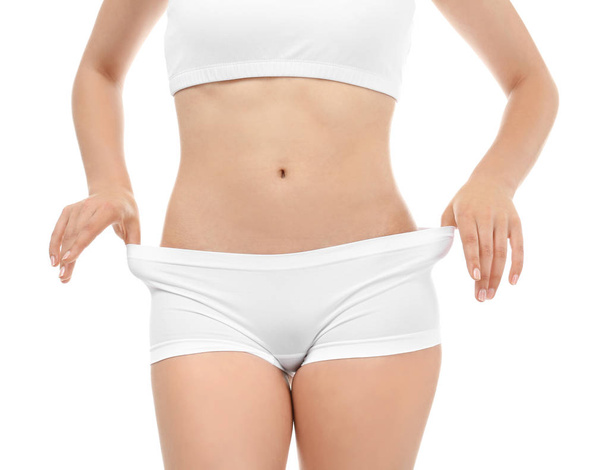 Young woman in underwear on white background. Diet concept - Foto, Bild