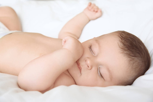 Cute little baby sleeping on bed at home - Foto, immagini
