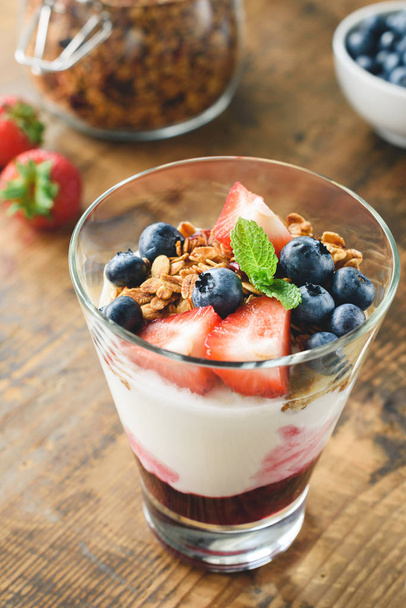 Yogurt parfait with granola, blueberry and strawberry - Photo, Image