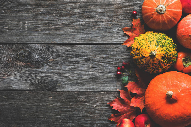Pumpkins and maple leaves on wooden background. Fall frame - Valokuva, kuva
