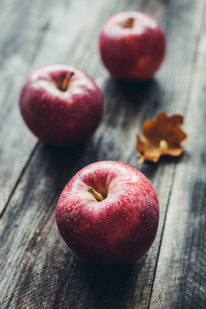 Red apples on wooden background - Фото, зображення
