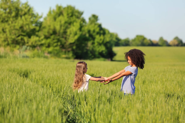 Happy little girls in green field - Photo, image