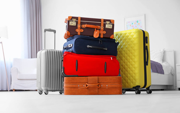 Different suitcases in light room. Luggage overweight concept - 写真・画像