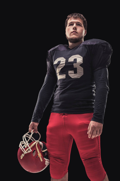 Football player on dark background - Fotografie, Obrázek