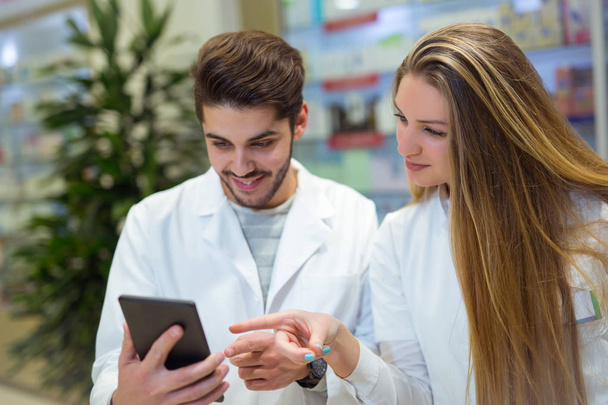 Pharmacists using digital tablet while checking medicine in phar - Foto, Bild
