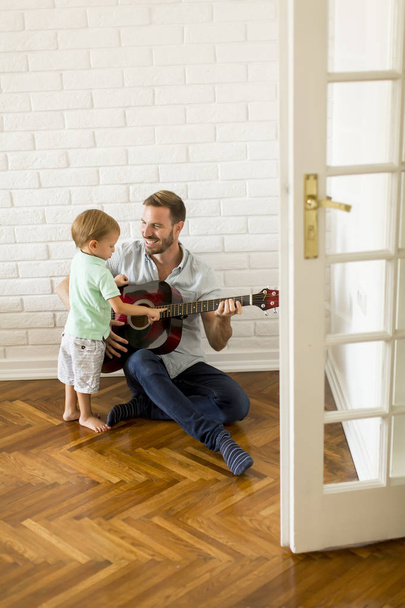 Father and little son with guitar - Photo, image