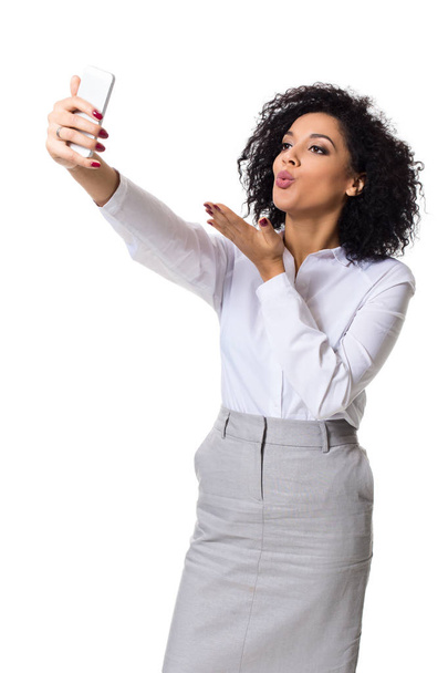 Beautiful brunette woman in classic white shirt and skirt make selfie on the phone. - Foto, Bild