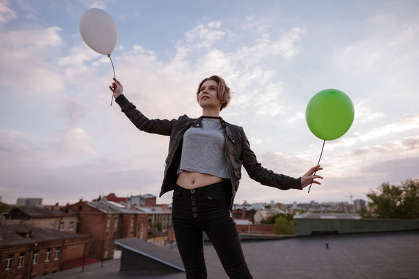 Enigmatic young woman with two toy balloons - Фото, изображение