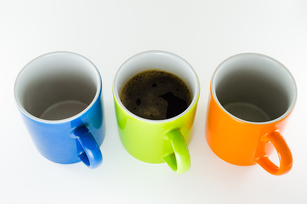 Three straight mugs with coffee mug in the center. - Foto, afbeelding