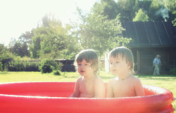 baby splashing in the pool outdoors - Photo, Image