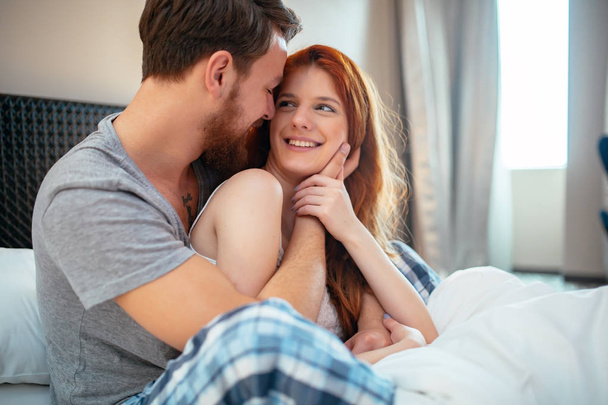 couple in bed showing emotions - Foto, Bild