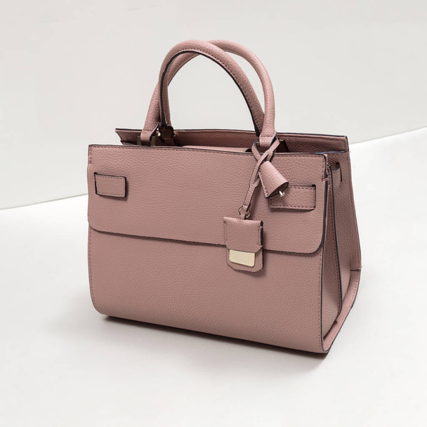 Beautiful luxury pink leather woman bag on a grey background - Photo, Image