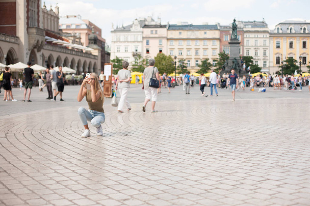 Krakow, Poland. Tourist taking photos in center of city - Fotografie, Obrázek