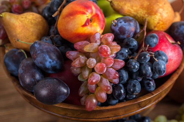autumnal fruit still life on rustic wooden table background - Photo, Image