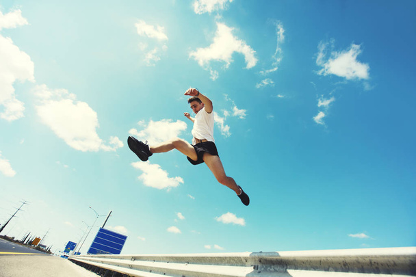 Young man jumping - fitness, sport, parkour, people concept  - Foto, afbeelding