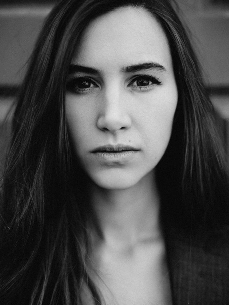 cropped portrait of young woman looking at camera - 写真・画像