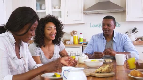 Family Eating Breakfast In Kitchen - Materiał filmowy, wideo