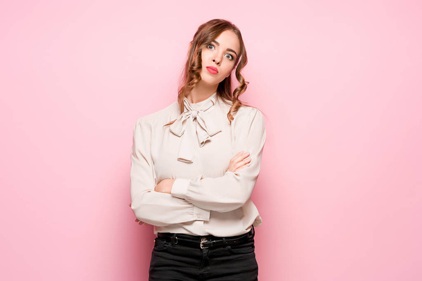 The serious frustrated young beautiful business woman on pink background - Фото, зображення