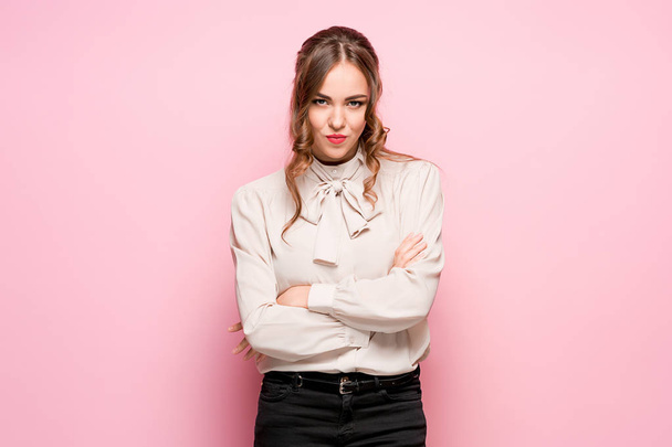 The serious frustrated young beautiful business woman on pink background - Foto, Bild