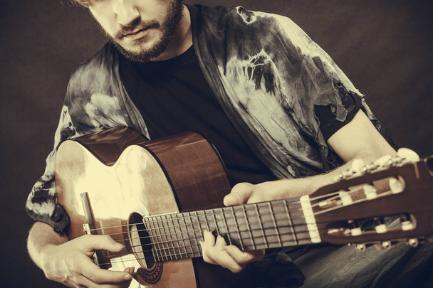 Closeup of man playing acoustic guitar - Foto, imagen